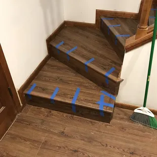 a picture of a staircase with tape on the steps