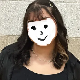 Beautiful blond streak makes her hair pop and sets her apart.