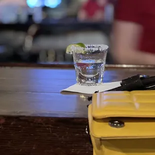 a yellow purse and a glass of water