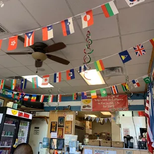 a restaurant with flags hanging from the ceiling