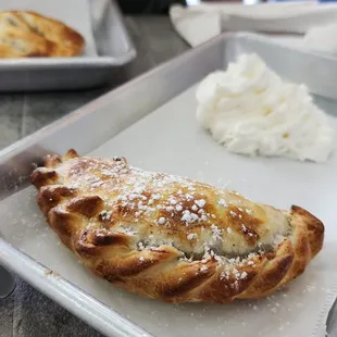 a pan of pastries and a plate of rice