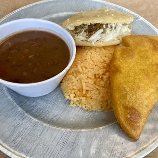 Empanada with ground beef, arepa with pork, rice and beans. Nice!