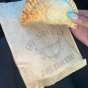 a person holding a piece of food in their hand