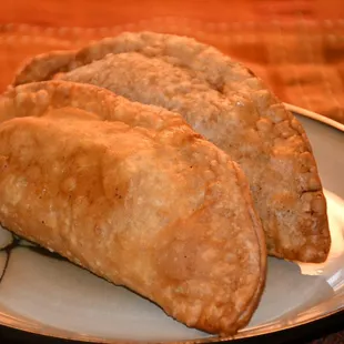 three empanadas on a plate