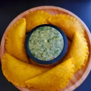 a bowl of salsa and a plate of mangoes