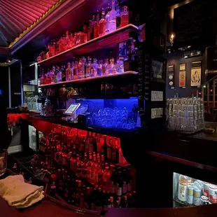 a bar with shelves of liquor
