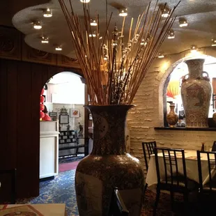 a large vase with sticks in it