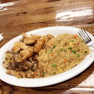 a plate of fried rice and chicken