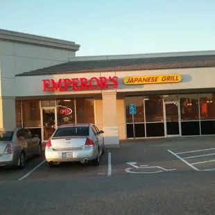 two cars parked in front of the restaurant