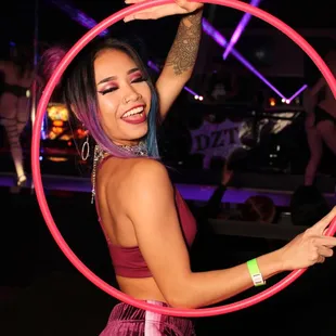 a woman holding a hula hoop