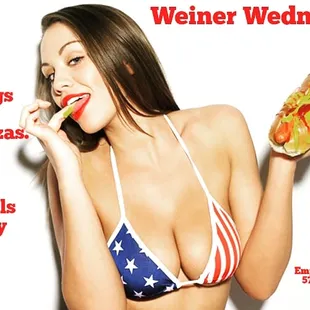a woman in a bikini eating a hot dog