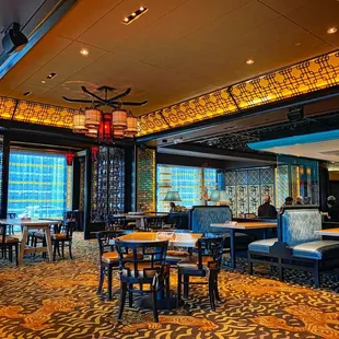 the interior of a restaurant with tables and chairs