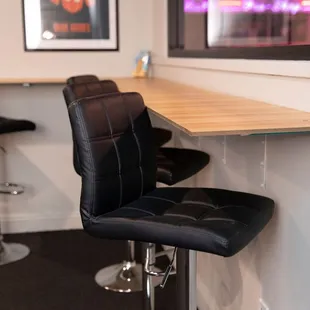 a bar with black leather chairs