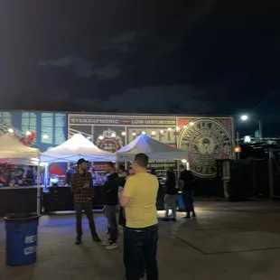 a group of people standing under tents