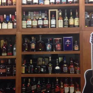 a shelf full of liquor bottles