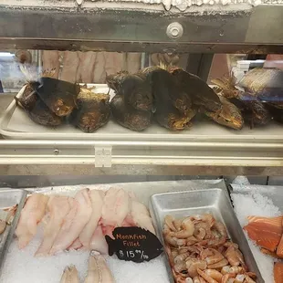 a variety of seafood in a display case