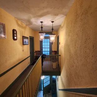 Standing at the top of the steps, looking toward second floor rooms.