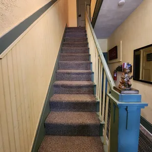 Standing at the bottom of the stairs looking up. It is the steepest staircase I've ever seen.