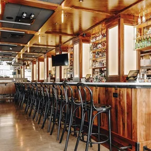 a bar with a row of bar stools