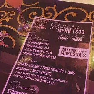 a menu and a drink on a table