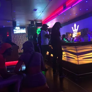 a group of people sitting at a bar