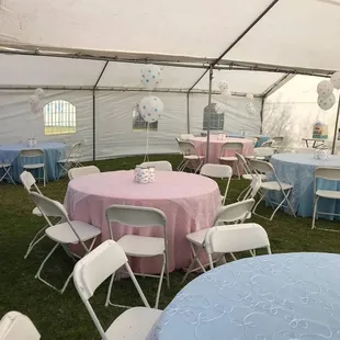 60 inch round tables, white chairs, Pink and blue linen, swirl organza overlay, under a canopy tent
