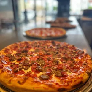 two pizzas on a table