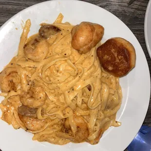  a plate of pasta and scallops