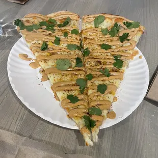 Single Elote pizza slice (cut in two to share) with Tajìn sprinkle, chipotle drizzle and cilantro. 100% unique and delicious!