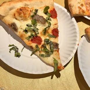 Fresh basil, sausage, tomato, pizza.
