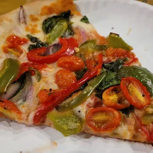 two slices of pizza on a paper plate