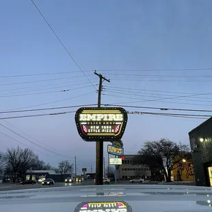 the reflection of the neon sign