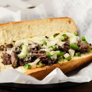 Philly Cheese Steak: Thinly Sliced steak, sautéed onions and bell peppers topped with Provolone Cheese on a toasted Italian Roll