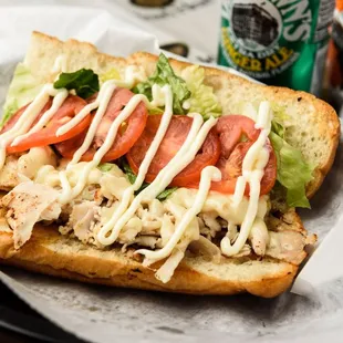 The Amy: Grilled Ovengold Turkey Breast, Melted Swiss Cheese, Lettuce, Tomato and Mayo on a toasted Italian Roll