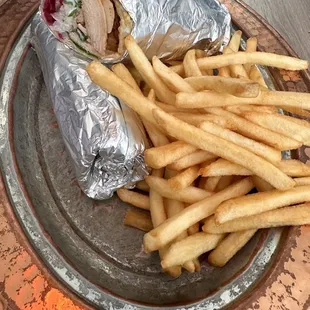 Chicken wrap with fries.