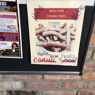 a sign on a brick wall