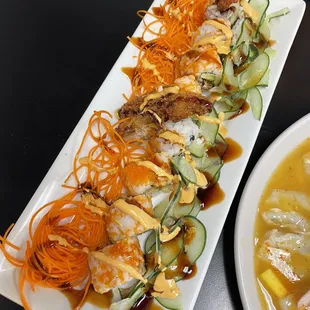 a plate of sushi and a bowl of soup