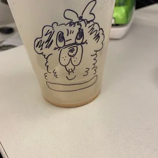 a cup with a dog drawn on it