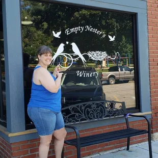 a woman standing in front of a window