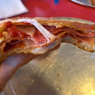 Inside of the Original Italian Meats calzone. Meaty and cheesy!