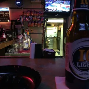 a bottle of beer on a bar counter