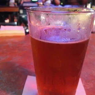a glass of beer on a napkin