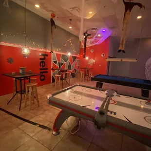 a game room with air hockey tables