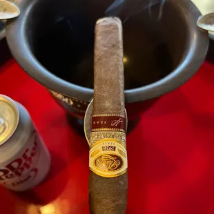 a cigar and a can of beer