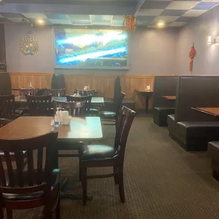 an empty restaurant with tables and booths