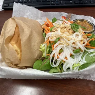 Buffalo chicken tender sandwich and a side salad.