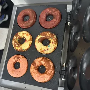donuts being cooked in a fryer