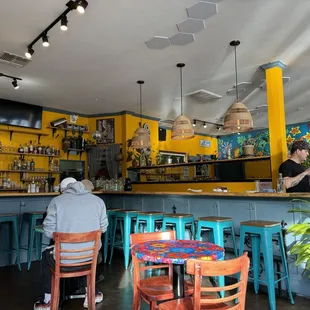 two people sitting at a bar