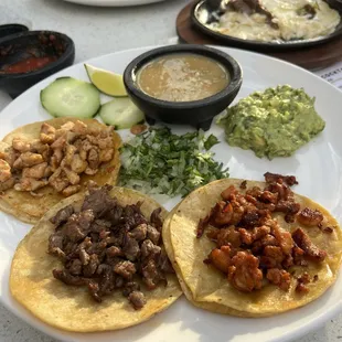 Taco plate (chicken, asada, al pastor) with two sides (guac and green chili)