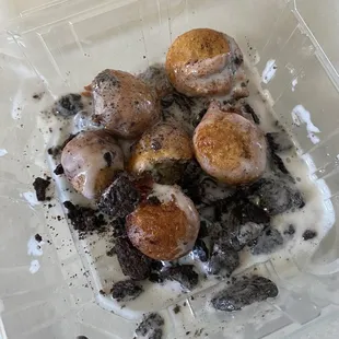 Dessert! Little fried donut holes topped with crushed Oreos and cream. On the house!!